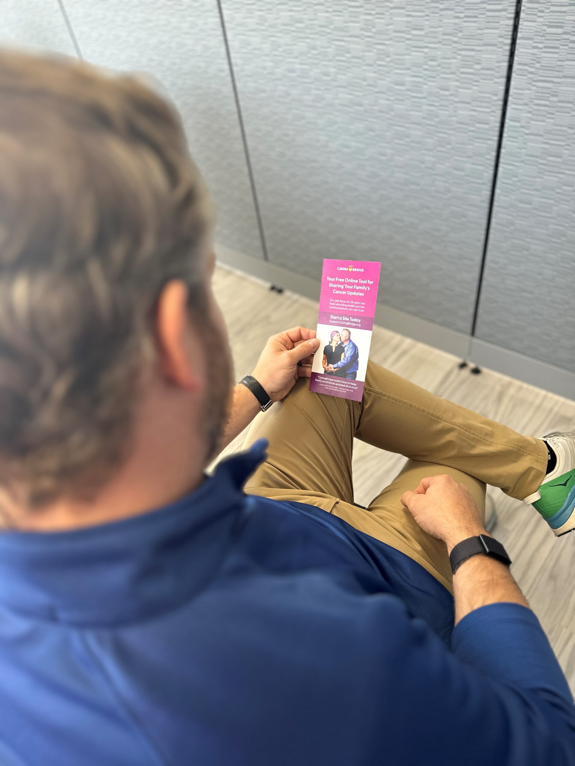 Family member looks over CaringBridge brochure to learn about creating a website for loved one.