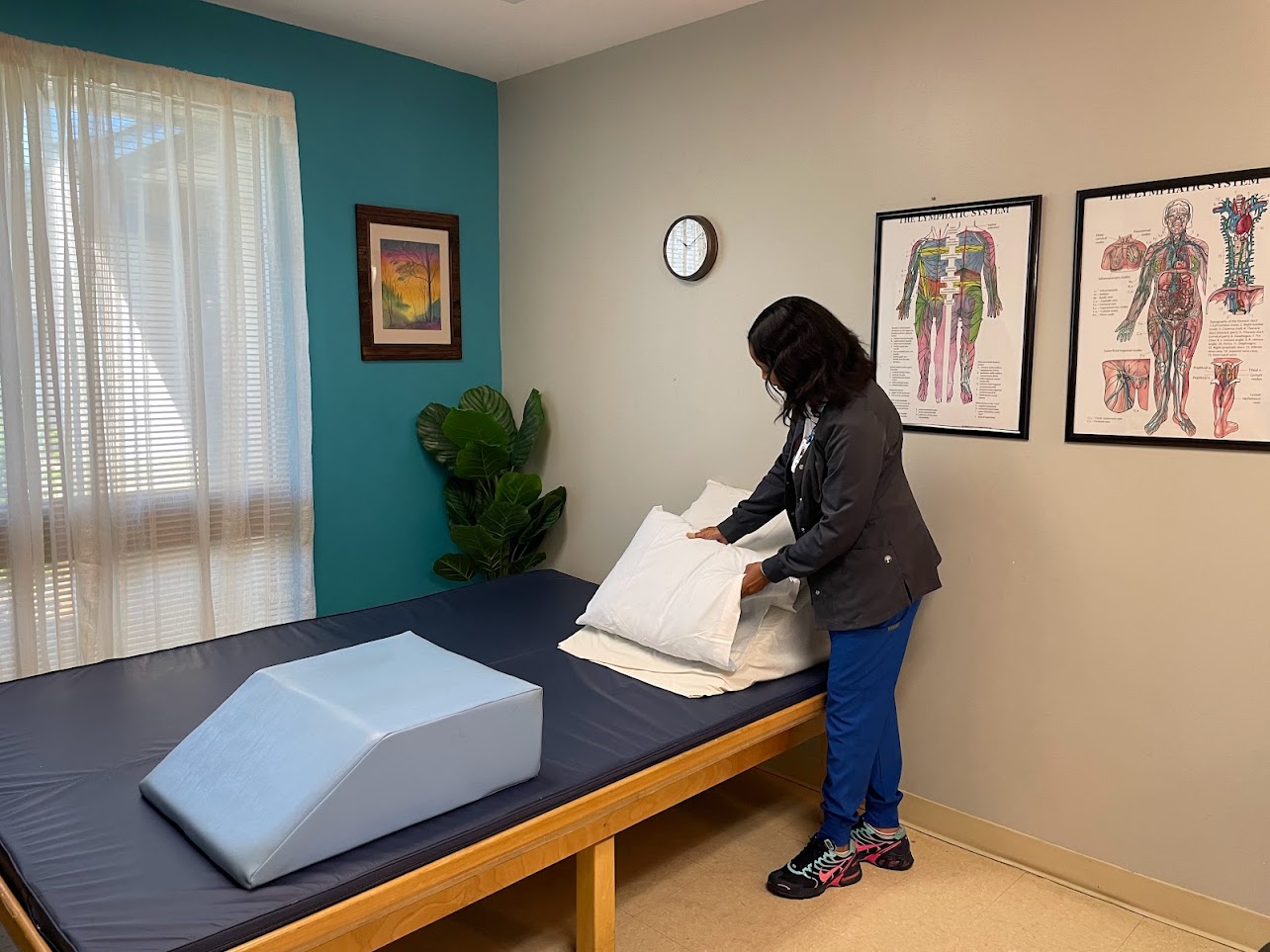 A therapist adjusts a pillow for a sleep therapy session.