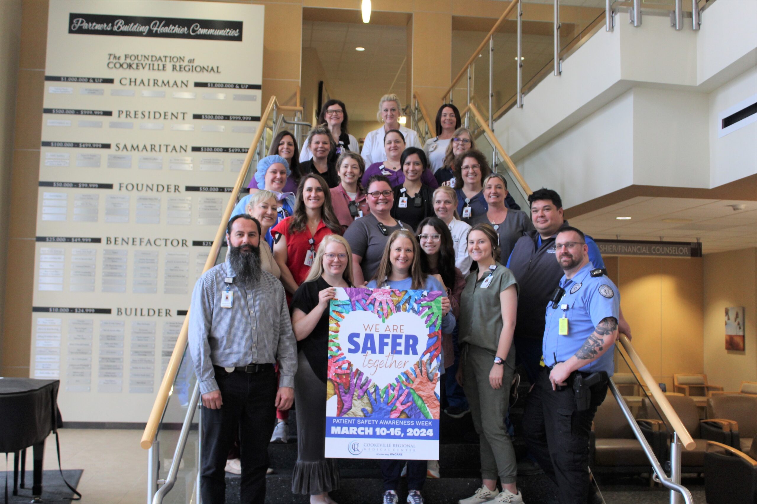 Photo of (STAFF) in front of the Patient Safety Awareness Sign at CRMC.